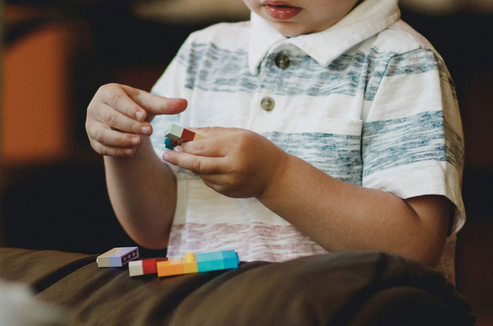 child playing with toy blocks