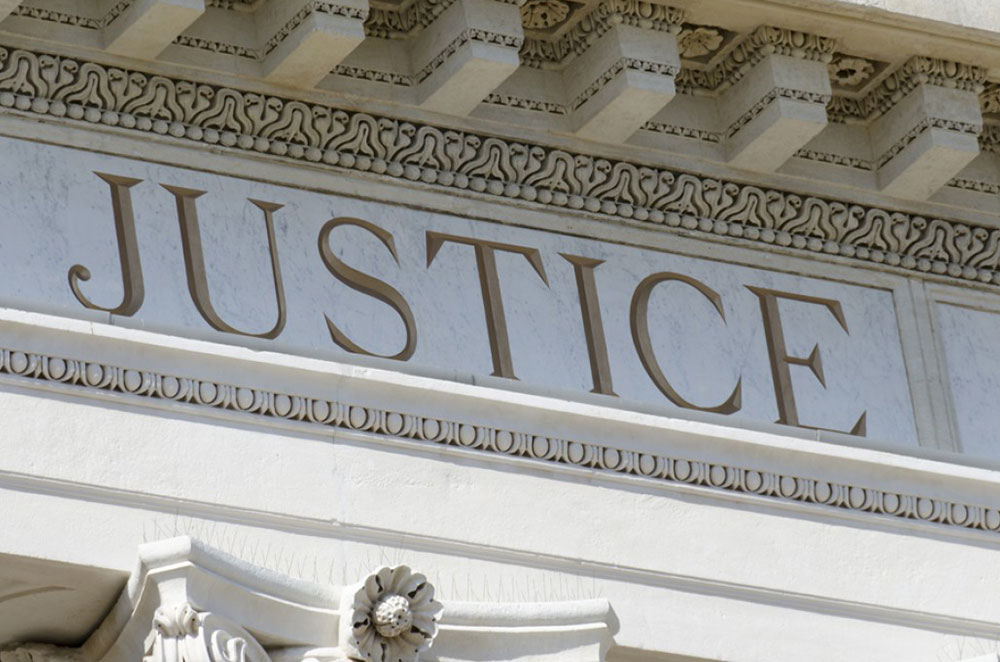 side of a courthouse with the word justice